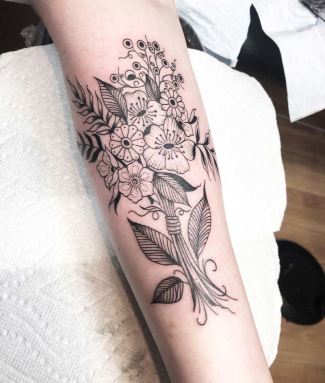 Flowers forearm black ink tattoo
