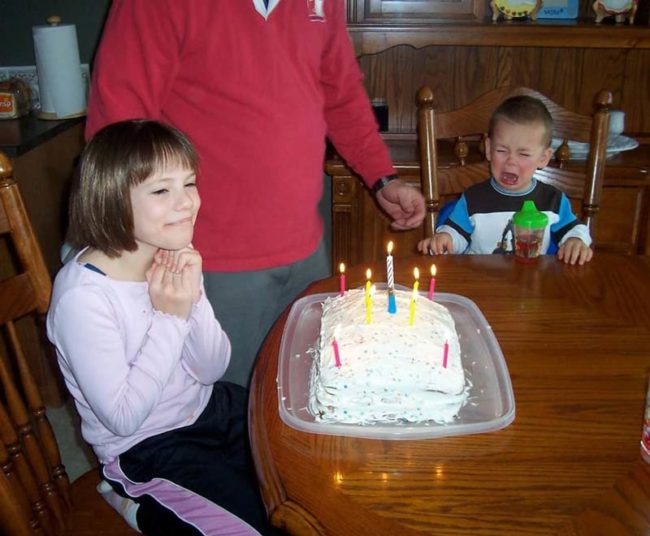 My brother crying because he can't blow out the candles. And me, enjoying the moment