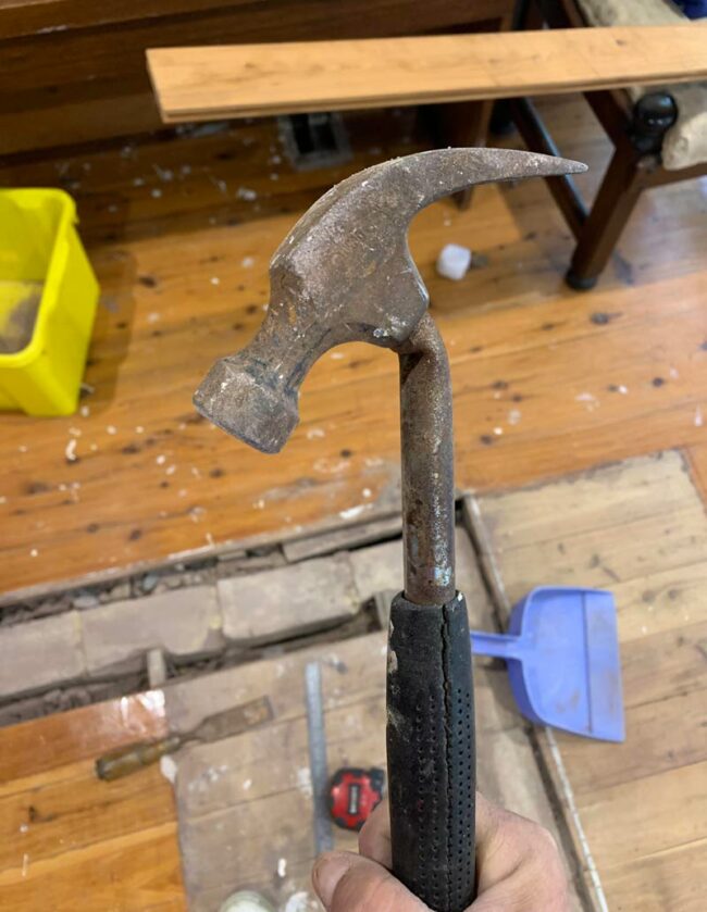 I broke a hammer trying to pry a nail out of the floorboards and it looks really disappointed in itself