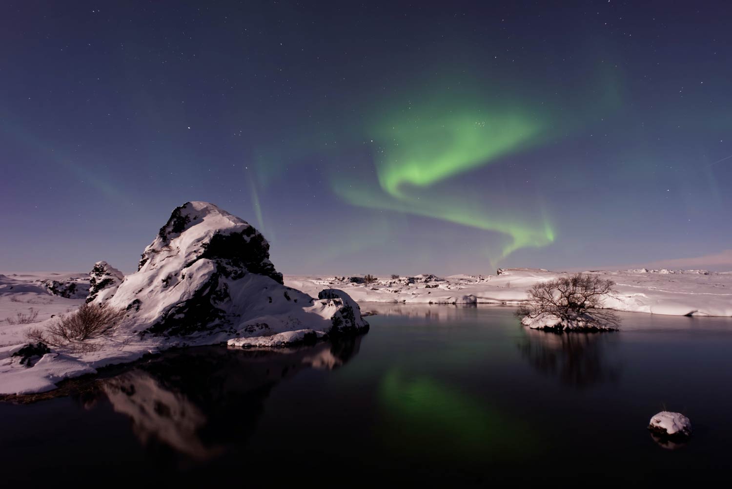 Northern Lights at a lake in Mývatn, Iceland