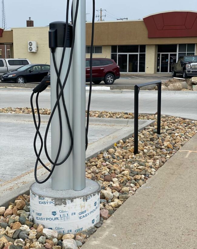 Electric car charging station and hitching post side by side