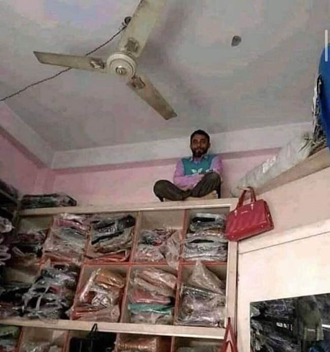 This guy works as a CCTV camera in a shop selling bags and purses in India