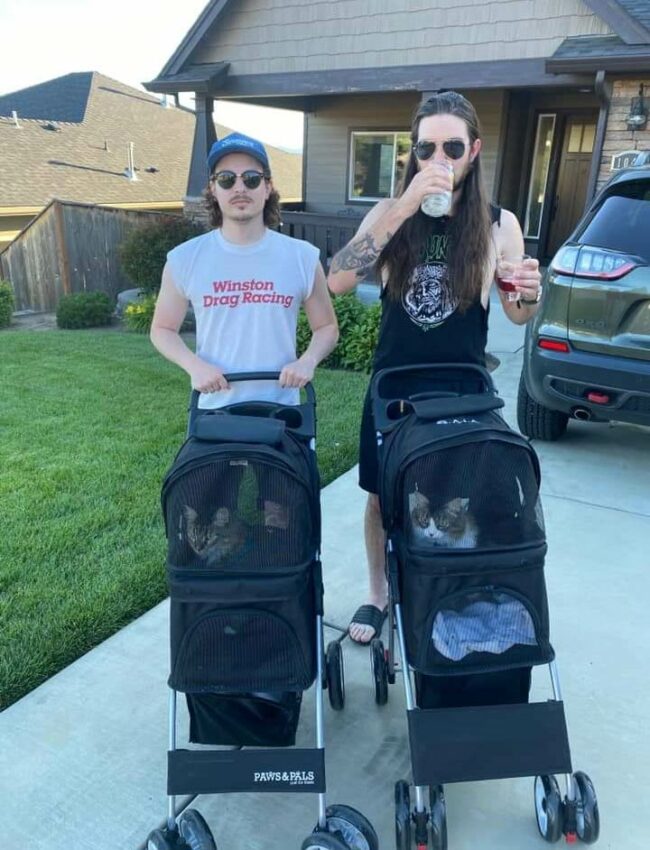 Just two guys walking their cats in strollers