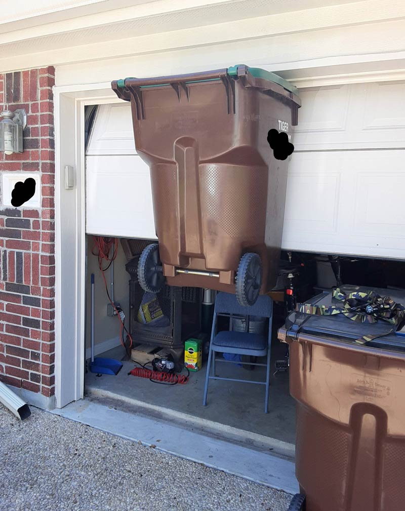 We were opening the garage door and the handle caught the trash can