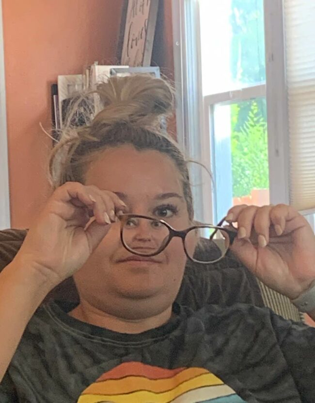 My husband took this picture of me this morning while I was trying to clean my glasses