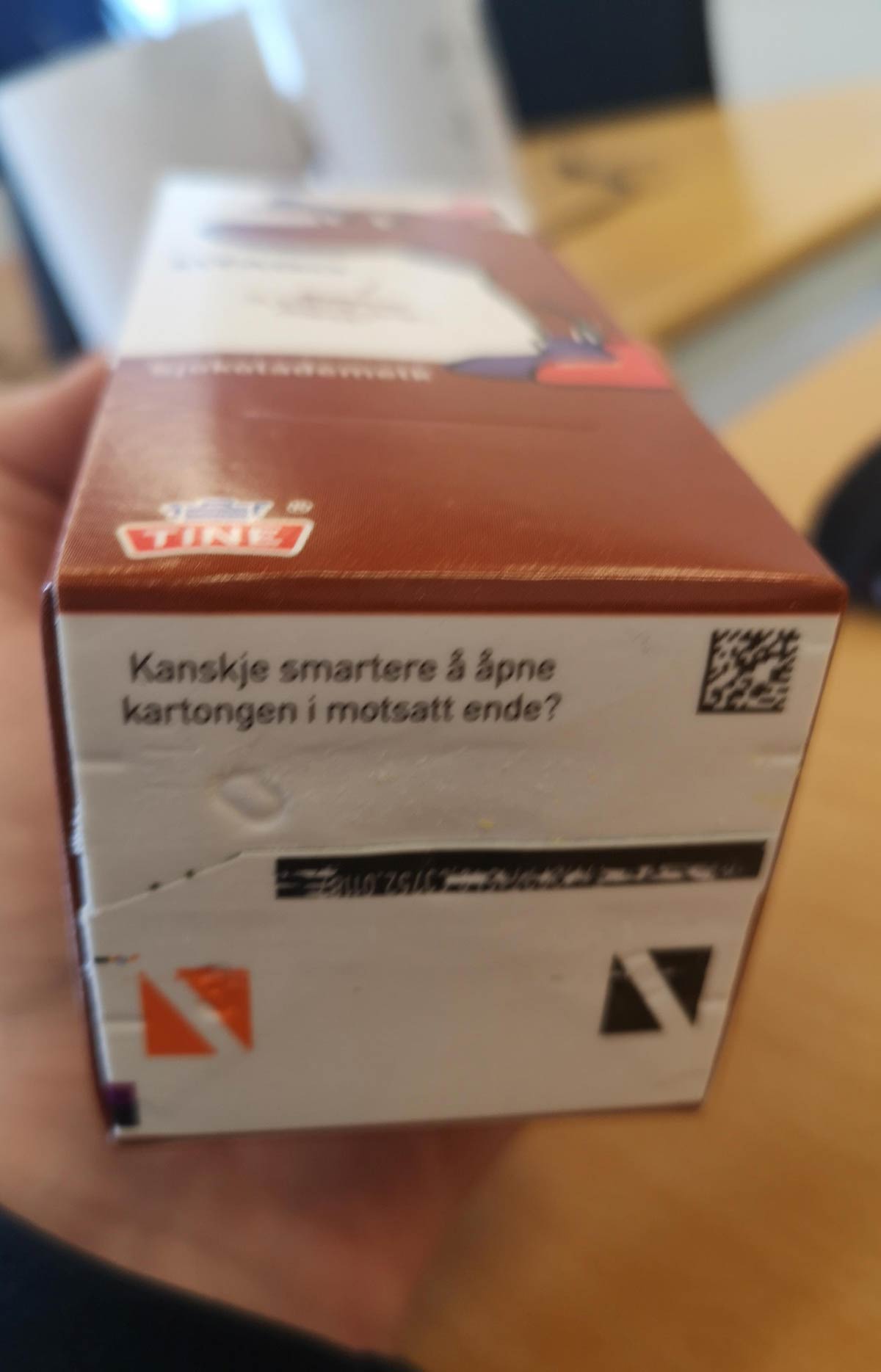The bottom of this chocolate milk carton says "Maybe smarter to open in the other end"