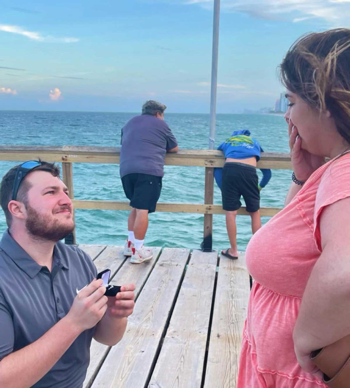 Proposed to my girlfriend yesterday and just noticed the guy in the back is not having a good time