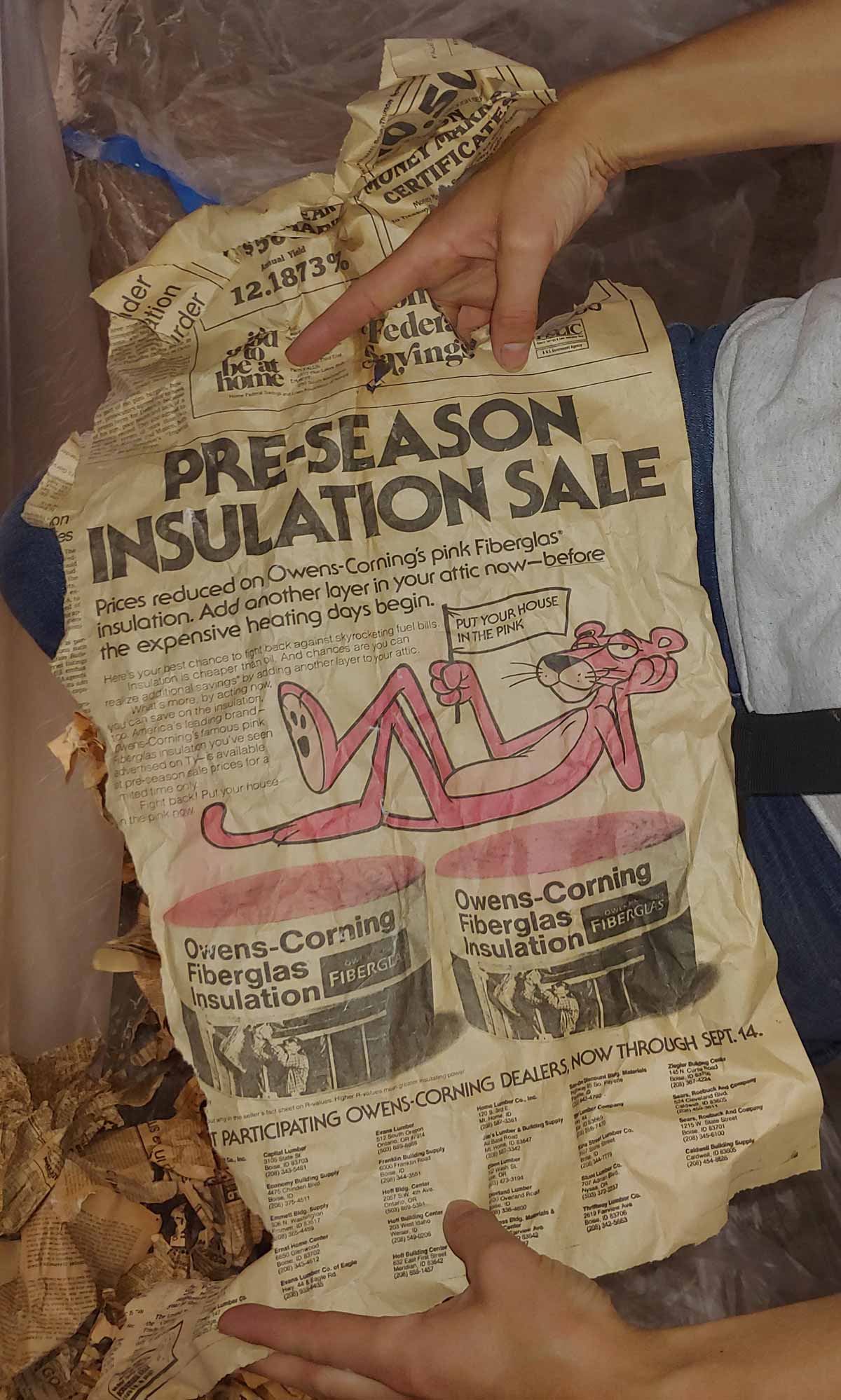 While insulating walls for a client, I noticed the small cavities above a window were filled with old newspaper. Pulled all the newspaper out so that I can install fiberglass insulation. This was one of the newspaper pages