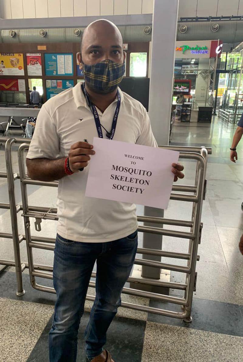 Driver with placard outside an Indian airport, for delegates for Asian “Musculoskeletal Conference"