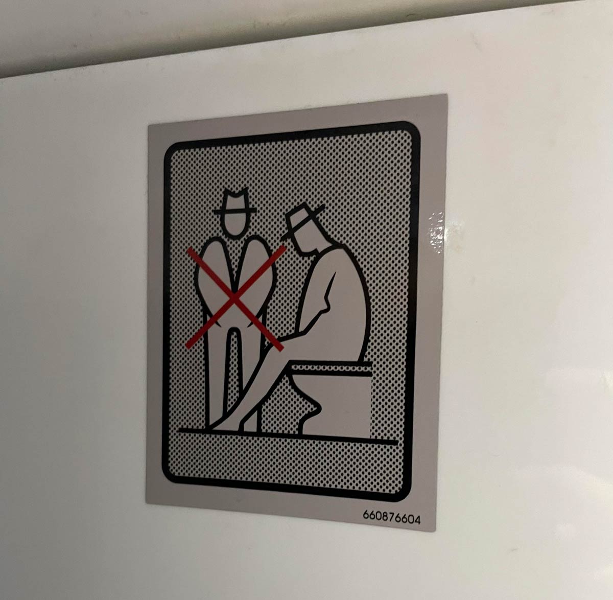 This sign in a bus bathroom forbidding an additional person from watching you poop