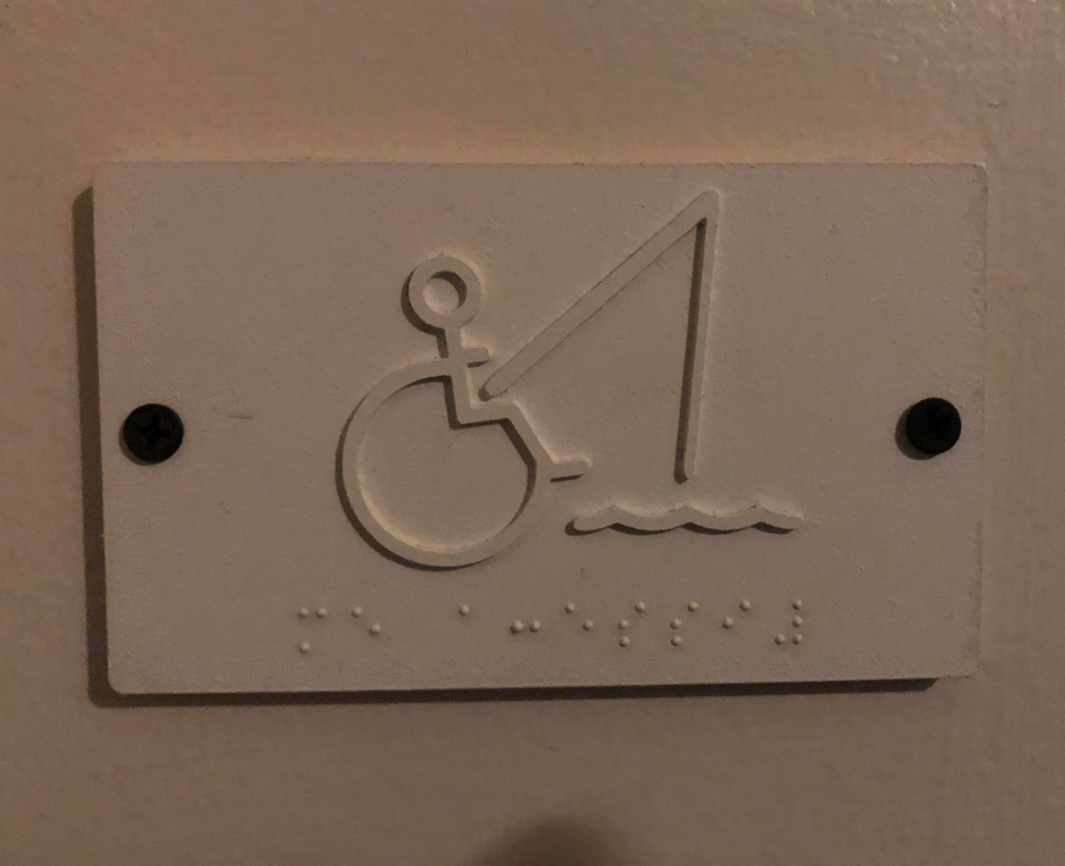 Bathroom sign for the men’s handicap stall
