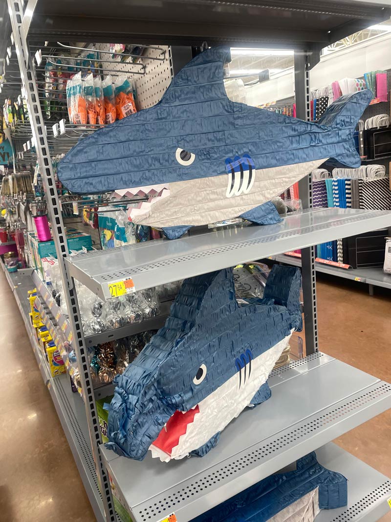 Shark piñata with the eyes on backward, making it look sad