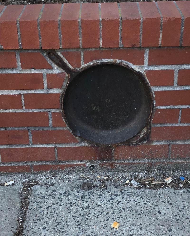 Somebody added a cast-iron skillet to their brick wall