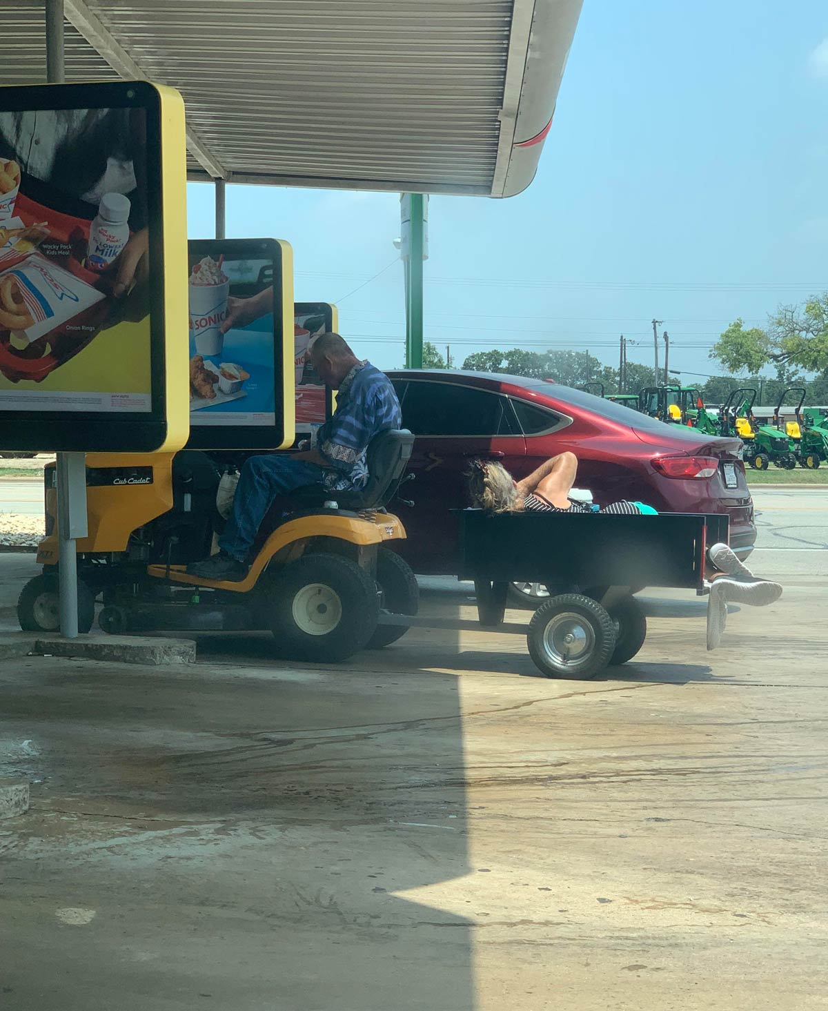 This man towed his wife to sonic on a lawnmower to get a vanilla ice cream cone