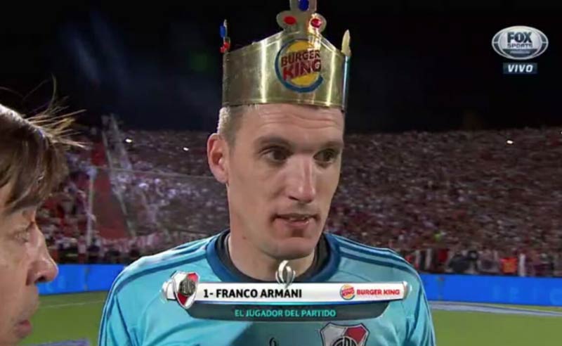 River Plate goalkeeper Franco Armani receives a paper crown for "Man of The Match" from competition sponsors Burger King