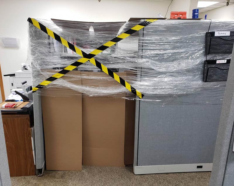 A co-worker went on a week-long business trip and came back to find their cubicle like this. Compliments of the sales rep across from him