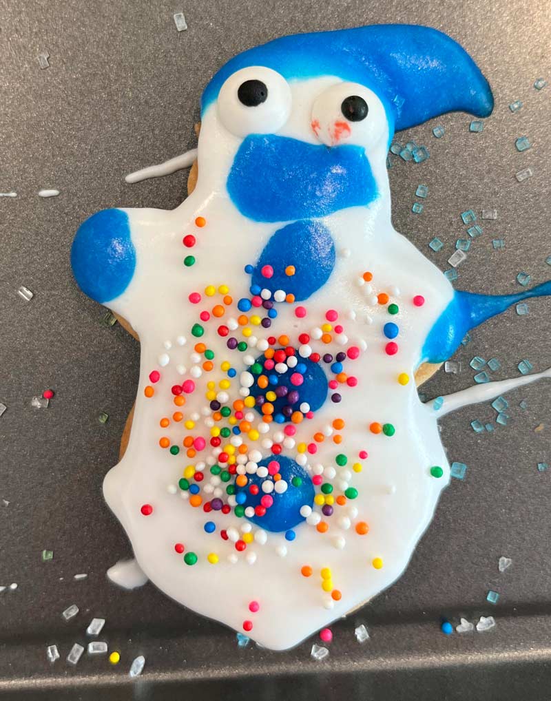 My snowman cookie looks like he’s forced into an eternity of suffering and pain