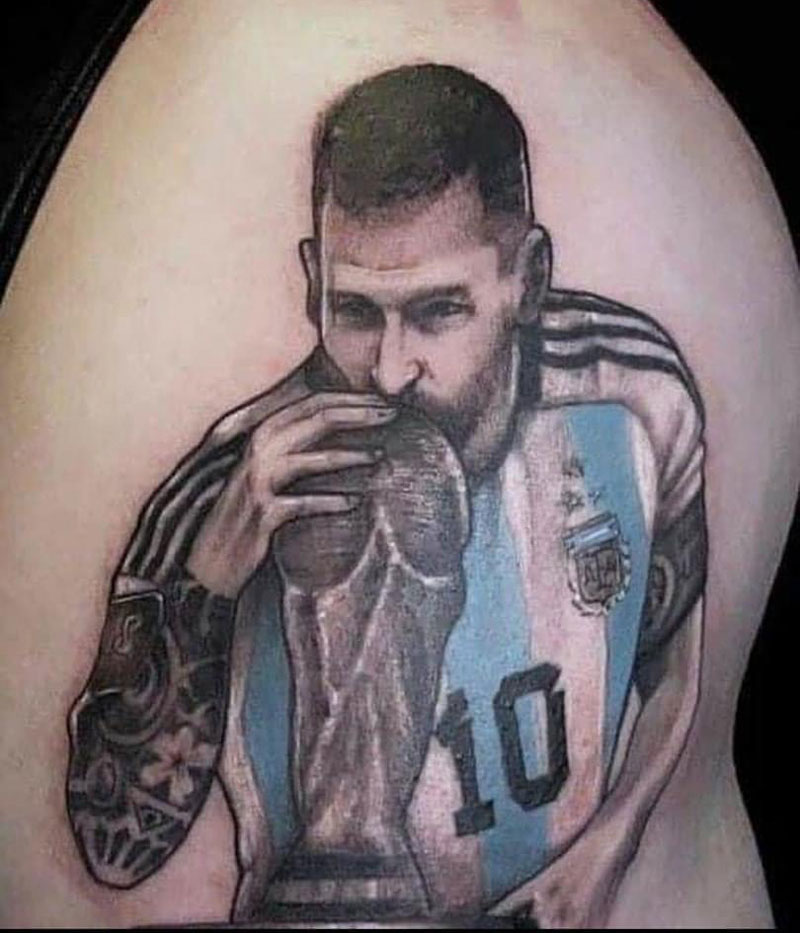 Messi kissing the World Cup tattoo