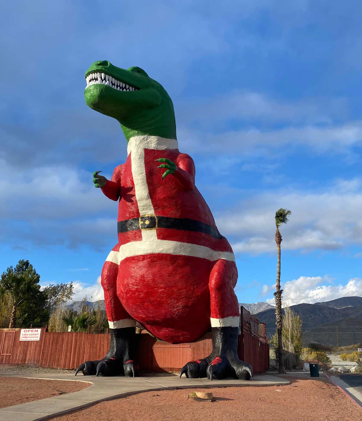 The dinosaur from Pee-Wee’s Big Adventure is dressed in a Santa suit during the holidays