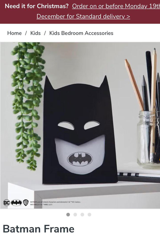 Unfortunately placed bat signal has made Batman look like he’s got terrible teeth