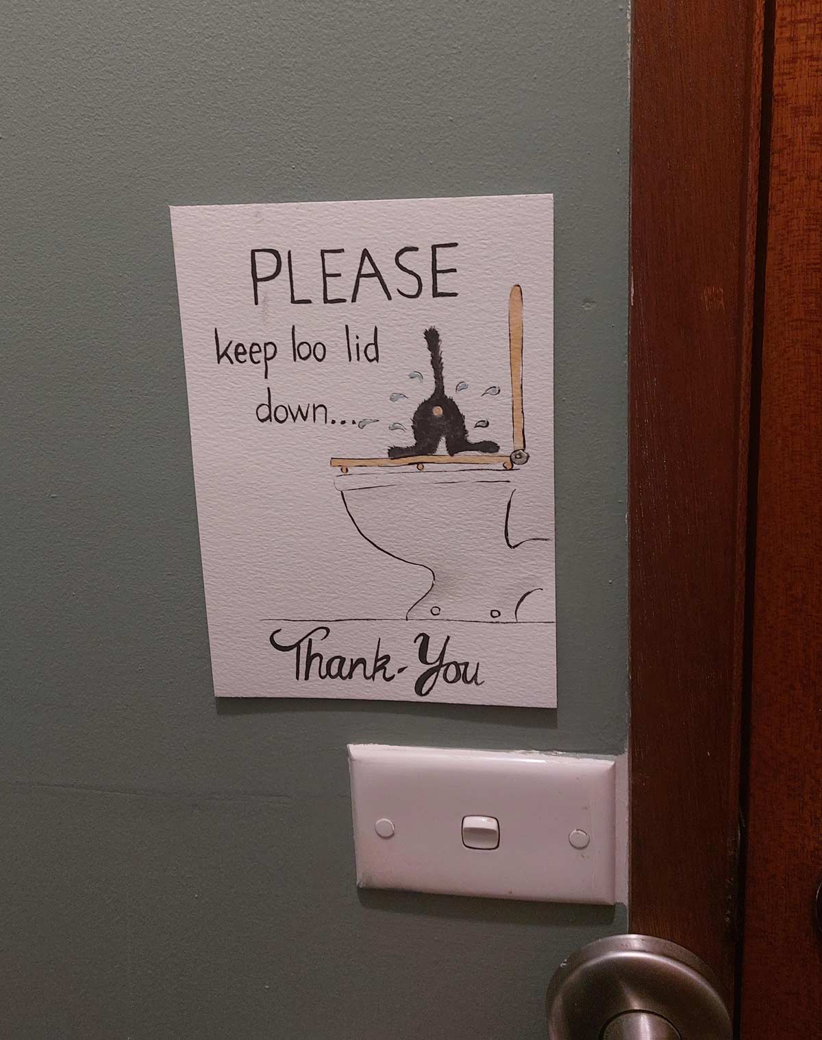 Our cat loves to play in the toilet water, so my mum made a sign to remind guests to close the lid after use