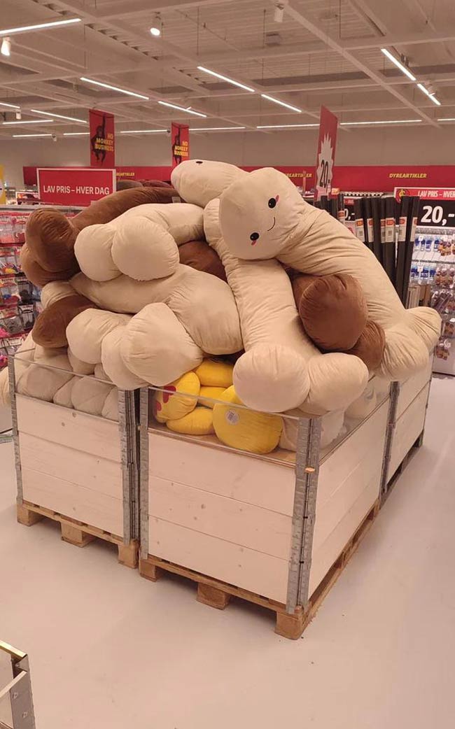 A big pile of happy plushies in the middle aisle of a Big Dollar shop