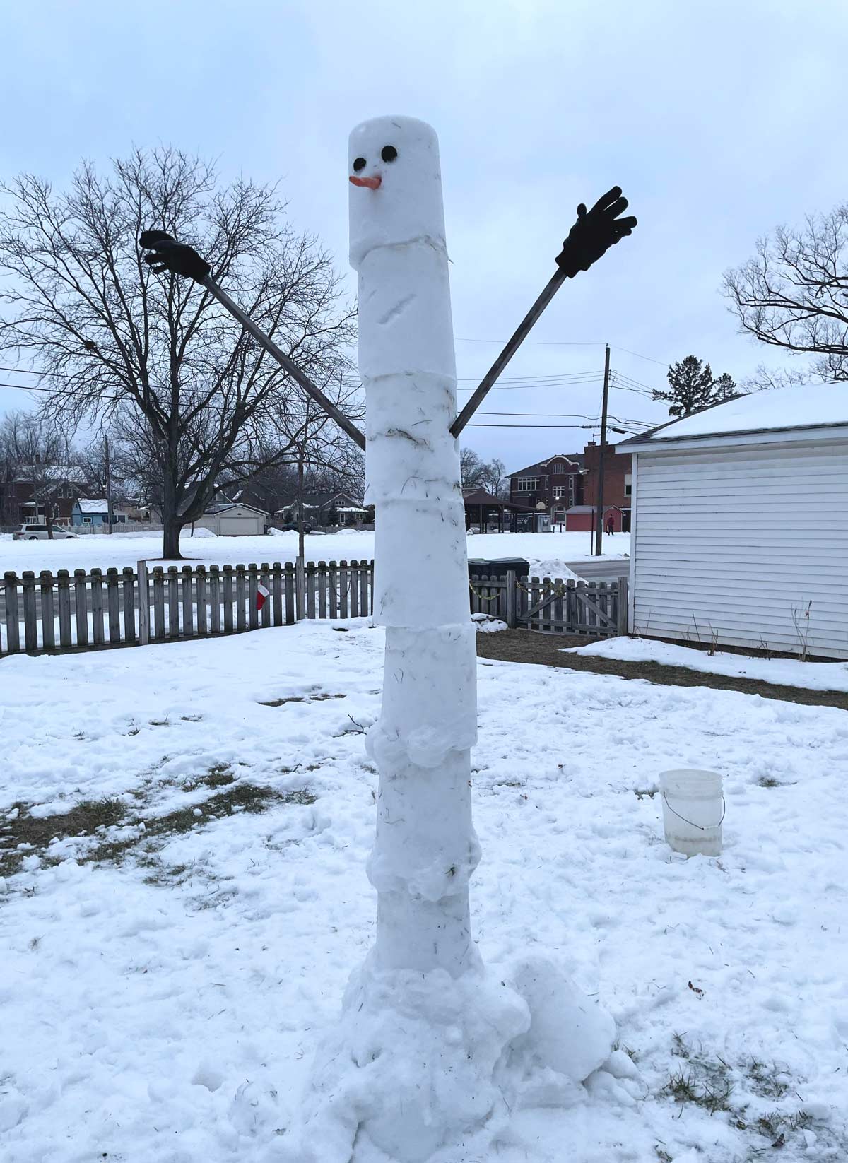 Tall skinny snowman made with a bucket