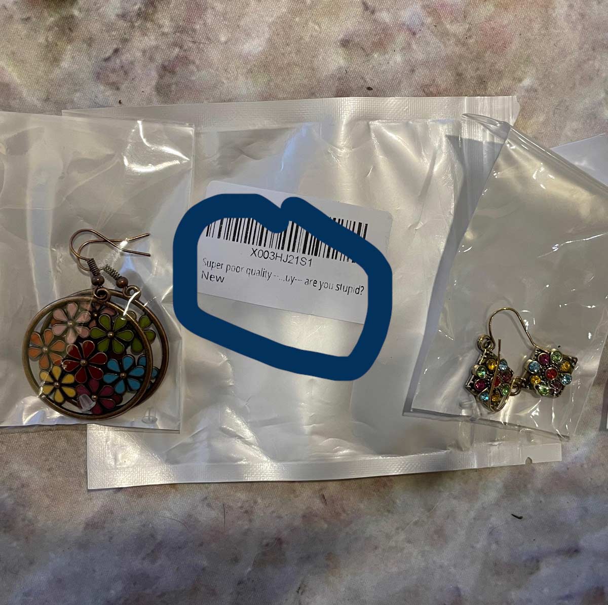 These earrings bought on Amazon are labeled “Super poor quality...by, are you stupid?”