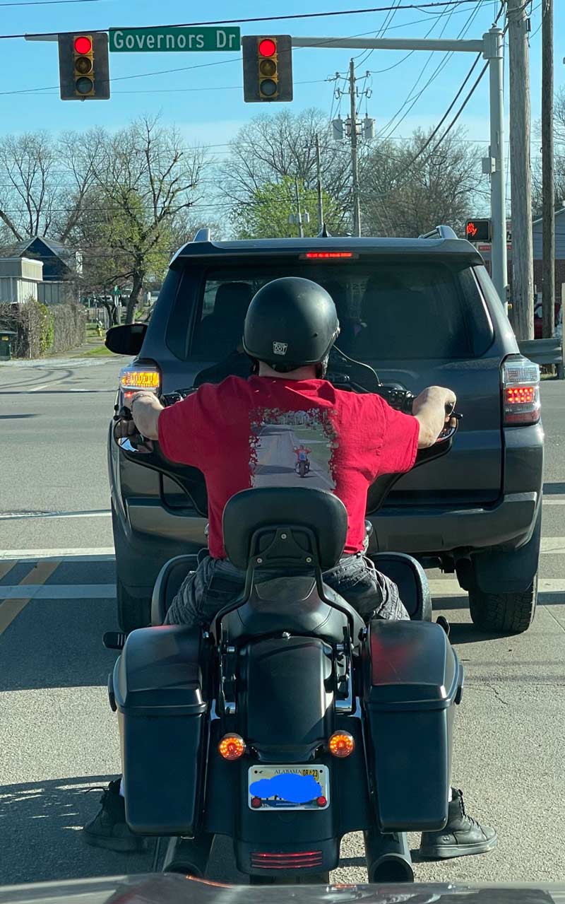 This guy riding a motorcycle has a shirt of him riding his motorcycle