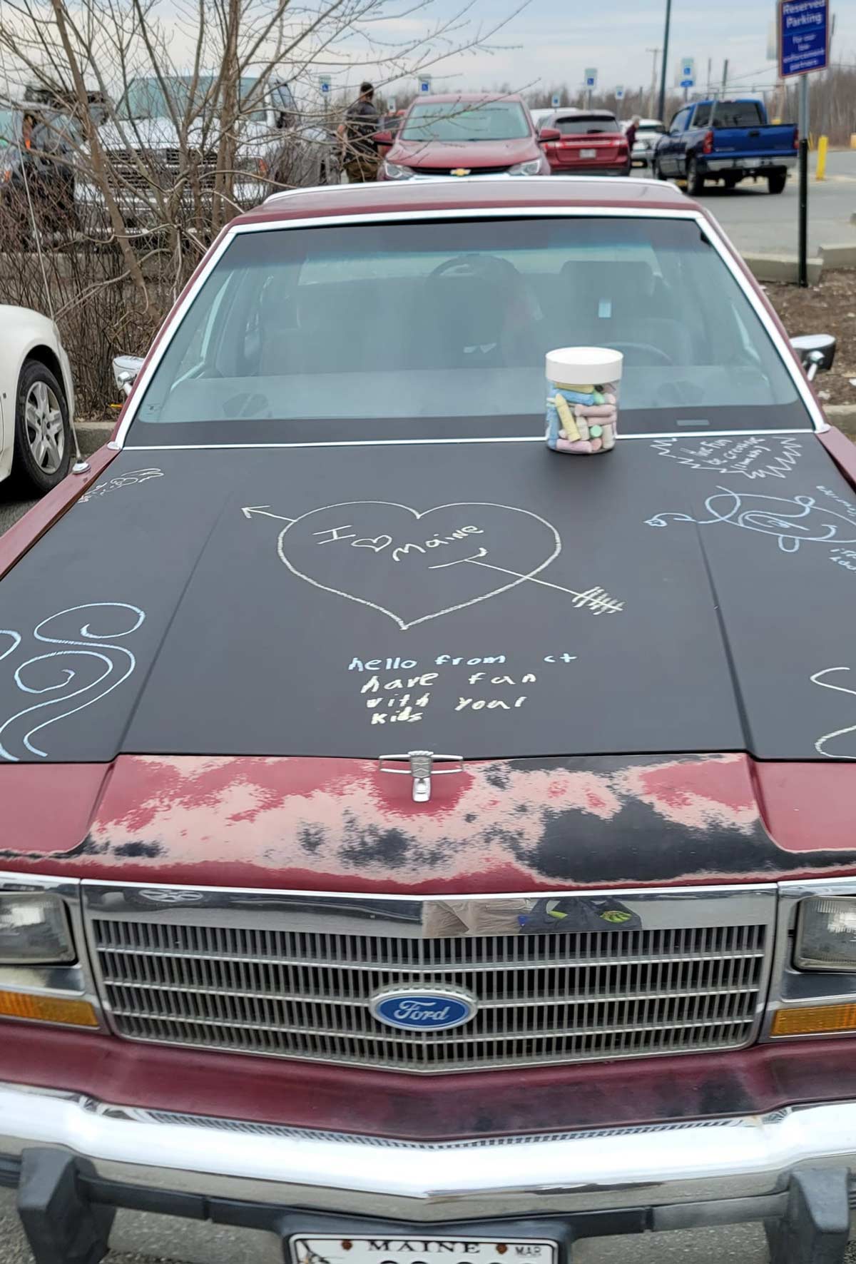 This car has a blackboard paint hood and bucket of chalk, allowing anyone to doodle on it as they pass by in the parking lot