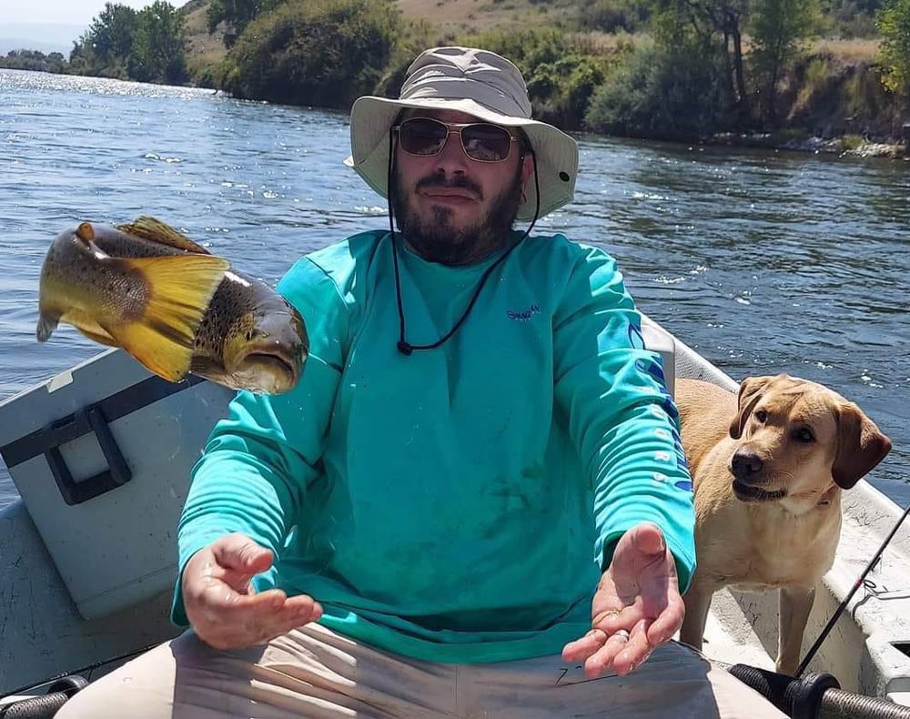A man, his dog, and a fish he thought was caught
