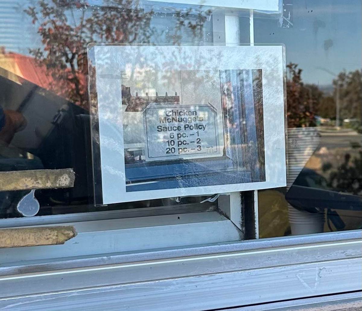 This McDonald’s taped their sauce policy on the drive thru window, which is a photo of their sauce policy, taped to their drive thru window