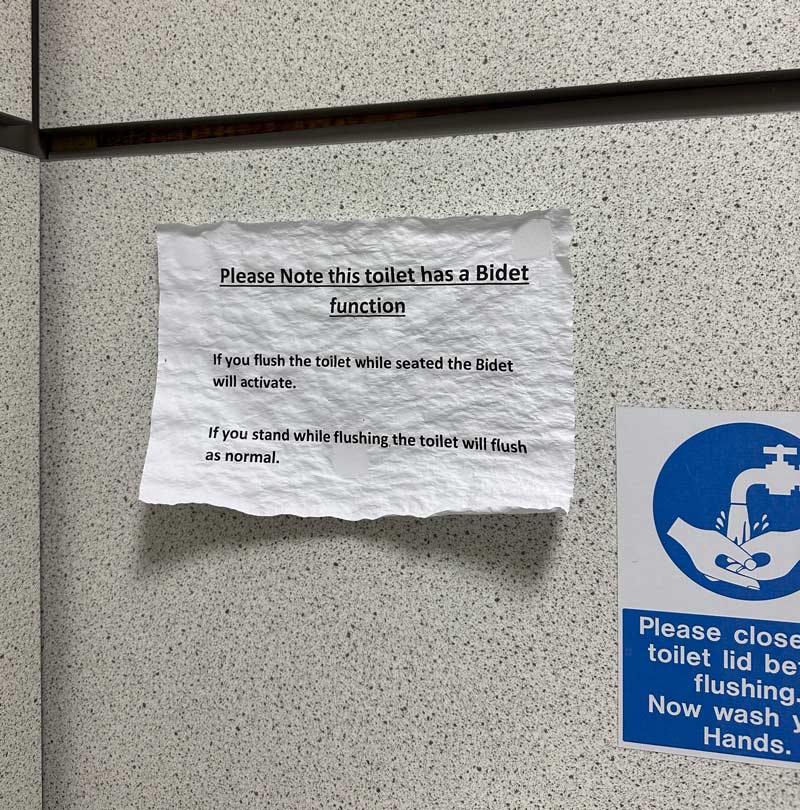 Sign saying the toilet now has a bidet has been soaked
