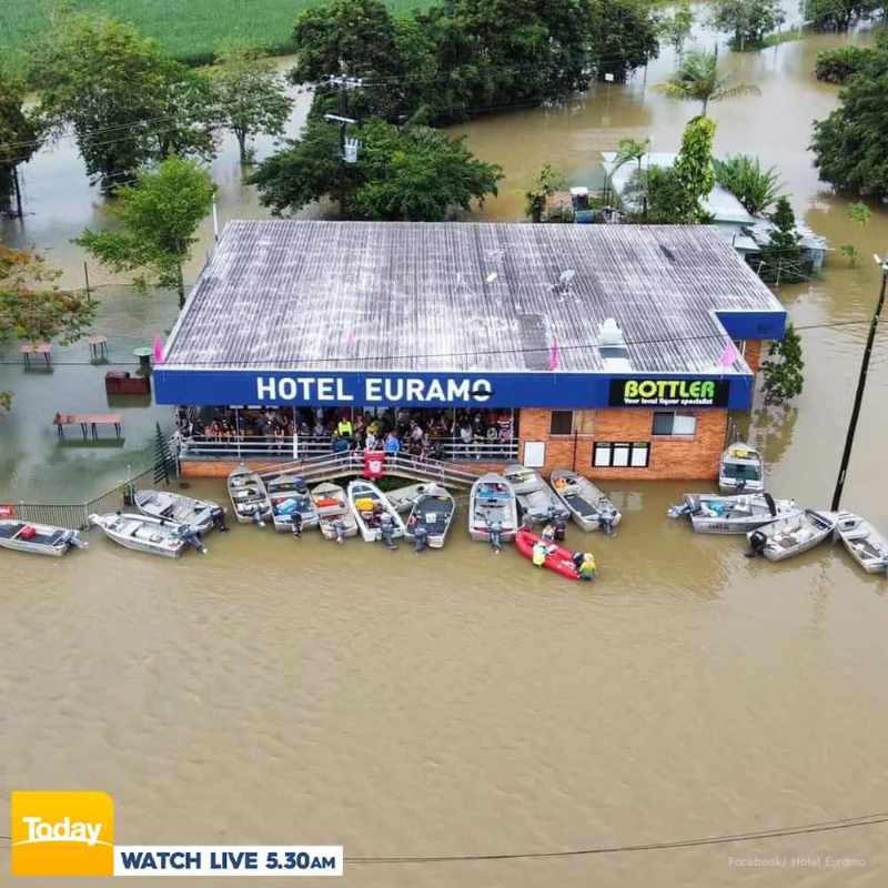 Floods in Cairns, QLD, Australia. Locals still attend the local pub in boats