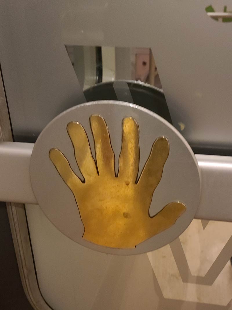 The hand on this push-door bar on a train in Finland has six fingers