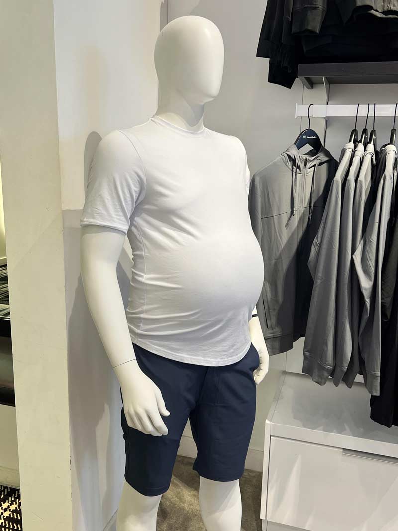 This golf store has a mannequin with a beer belly