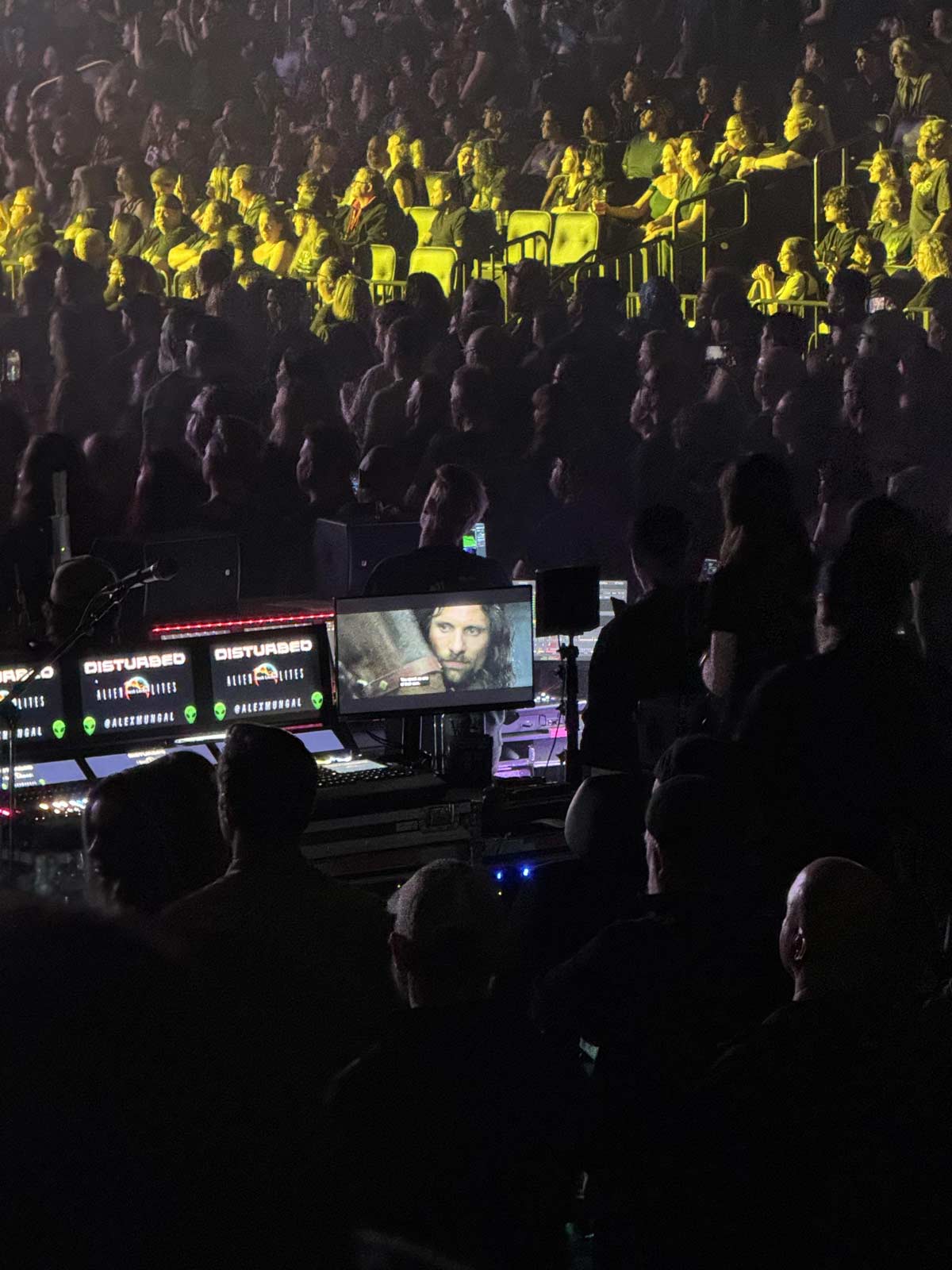 Technical crew watching Lord of the Rings during a Disturbed concert