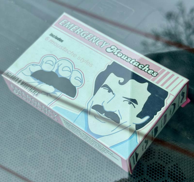 Box of emergency moustaches in car window