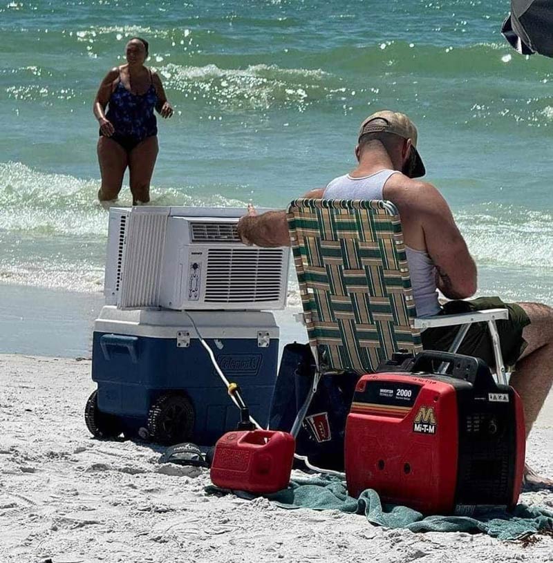 A man at the beach with an air conditioning unit