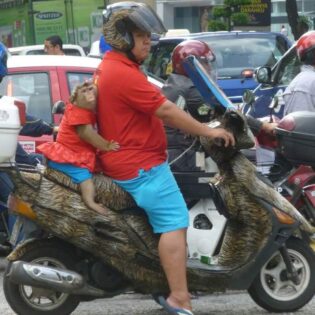 Picture I took 10 years ago in Malaysia. Originally thought it was a toddler without a helmet