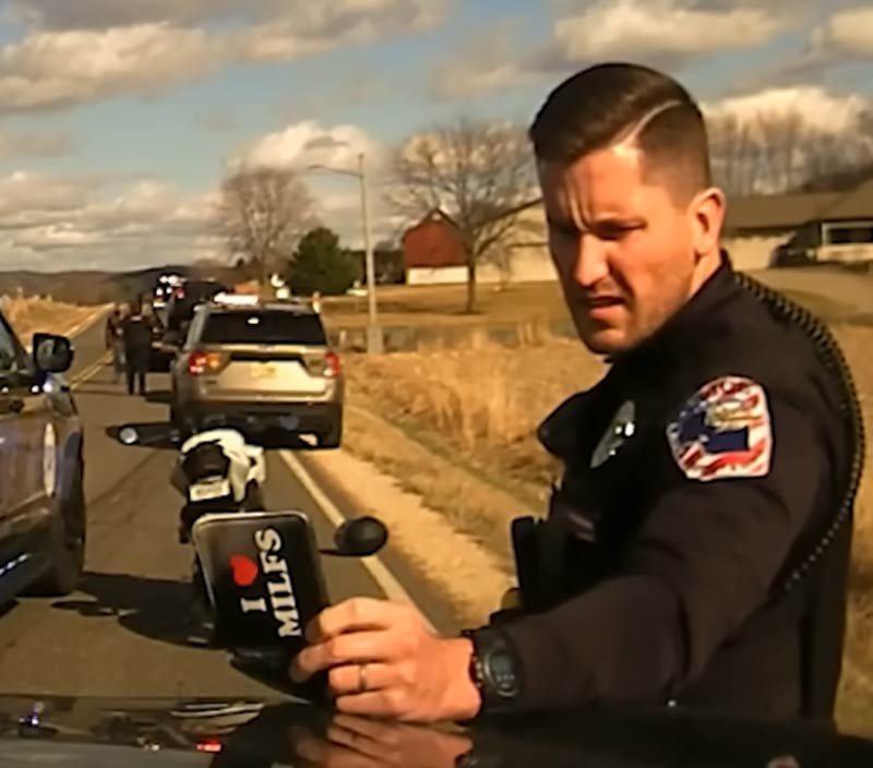 Police officer looks through a suspects belongings