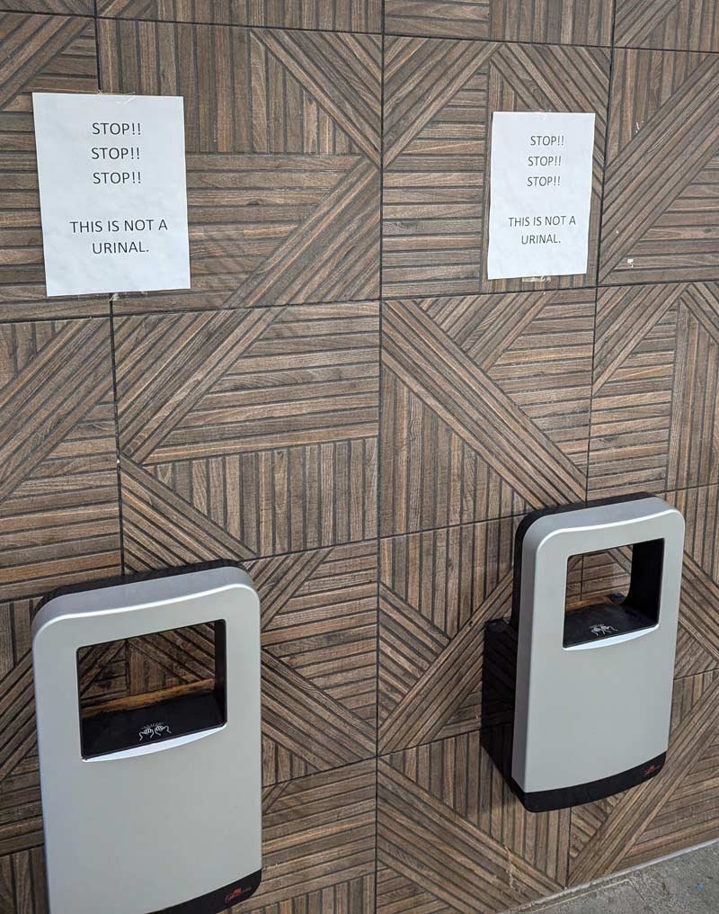 These are hand dryers in the men's bathroom in an Australian truck stop