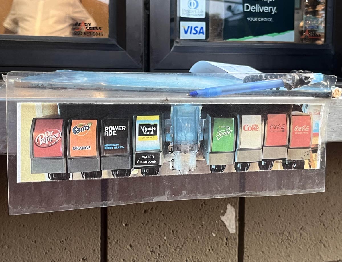 Instead of listing out their drinks, this drive thru just uses a printed photo of their soda fountain