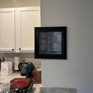 How my girlfriend’s brother hangs a painting in his kitchen