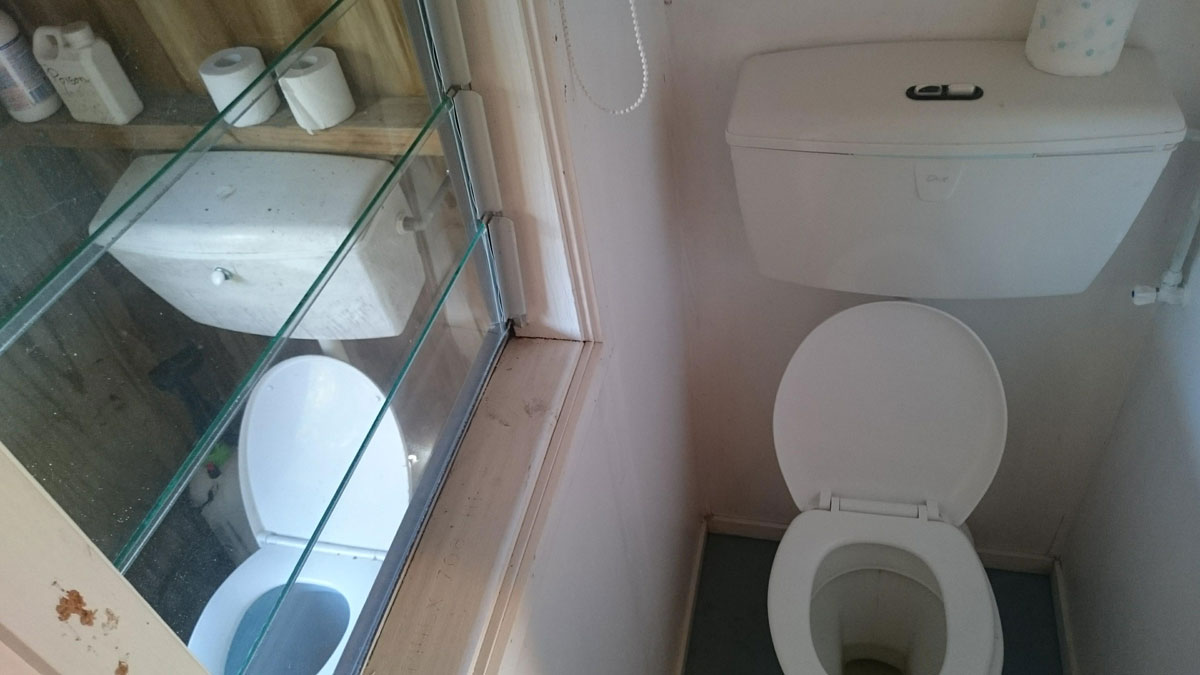 A window between two toilets at a place I once stayed at