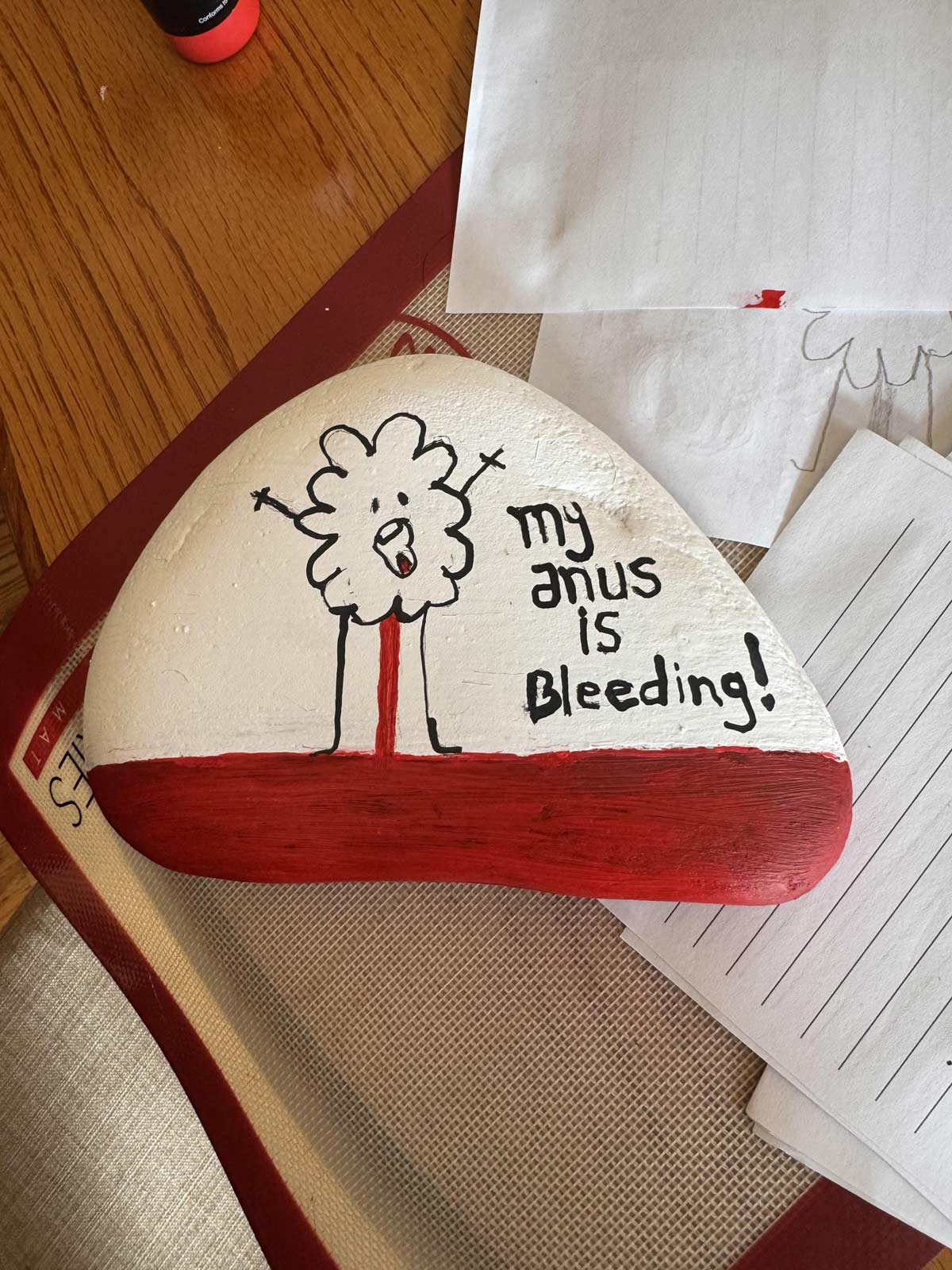 My mom painted a rock for a friend who had to cancel a trip because his hemorrhoid burst and he had to go to the ER instead of the airport