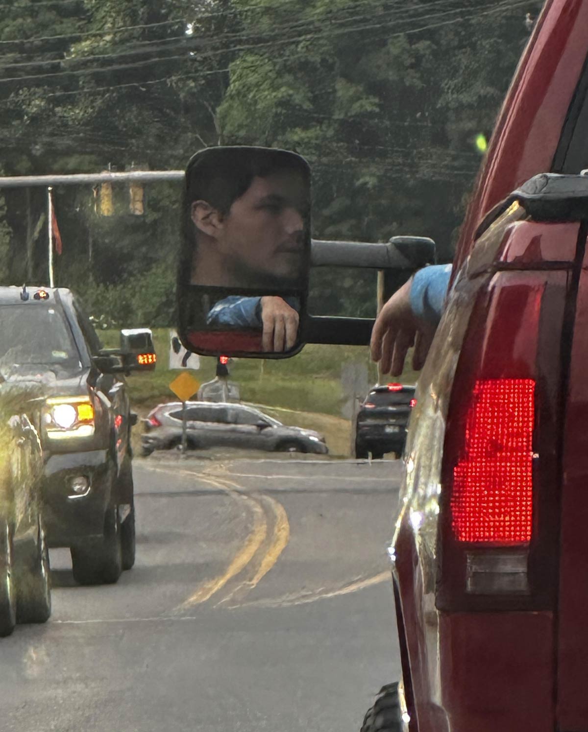 This guy's mirror makes it look like he has a huge head and tiny arms