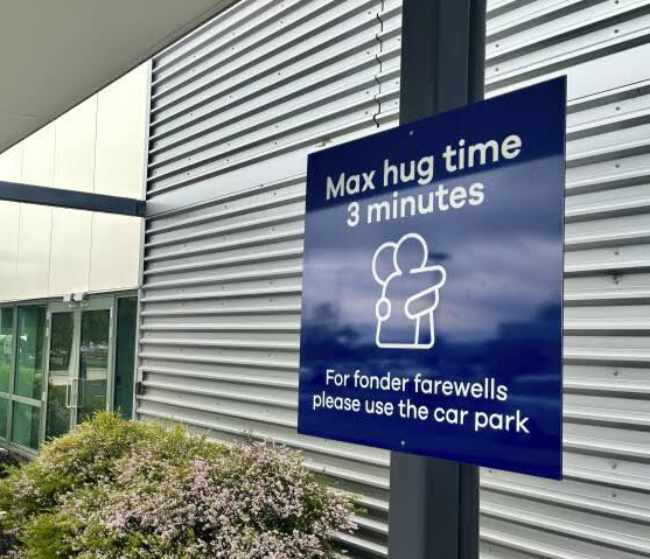 Dunedin Airport in New Zealand installed signs limiting hugs to 3 minutes